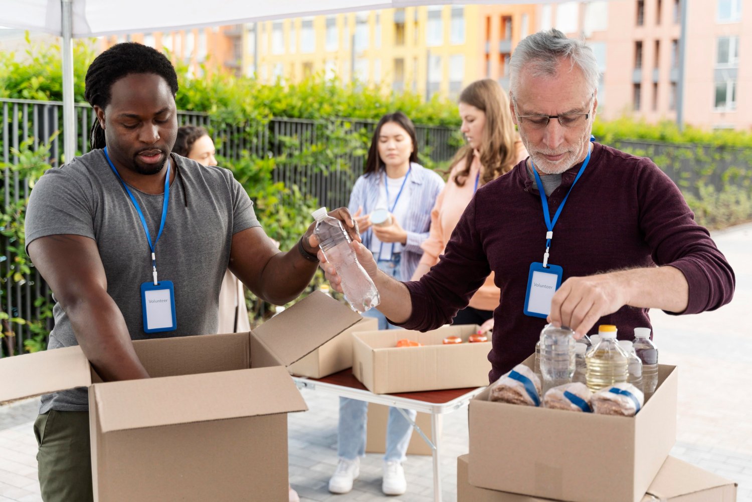 Volunteers organizing water and essential supplies for distribution.