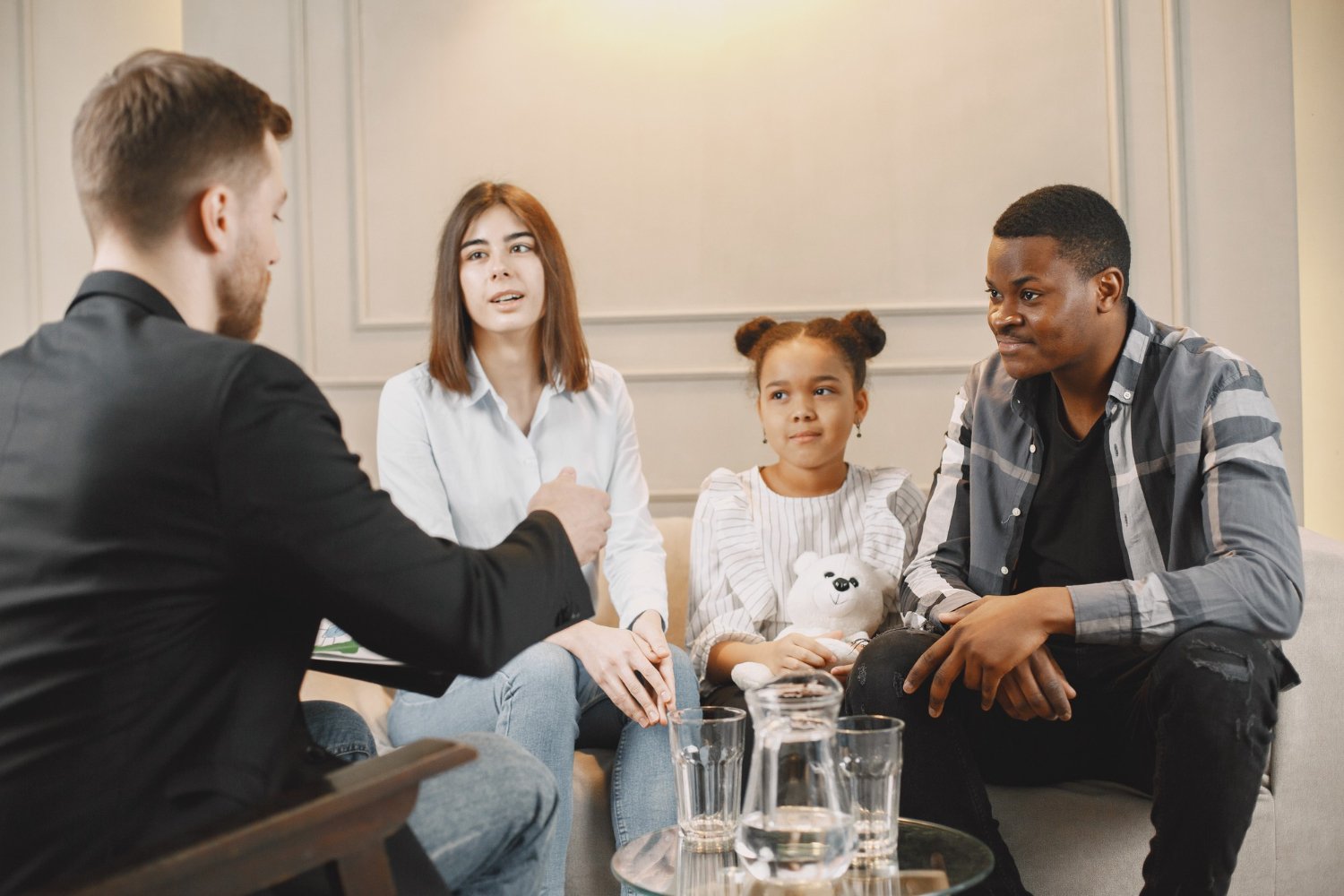 Family members seated together in conversation.